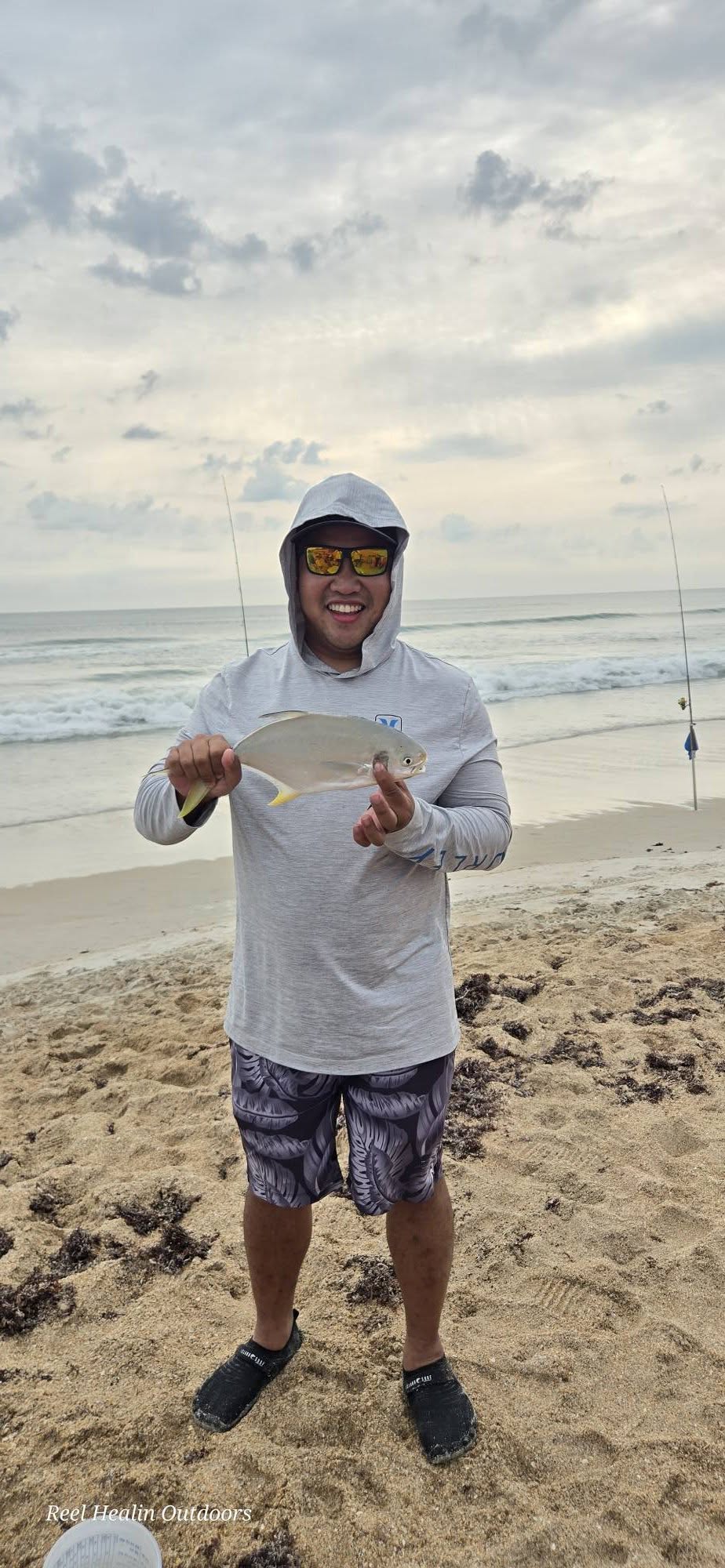 Florida pompano catch displayed on New Smyrna Beach with fishing rods in background
