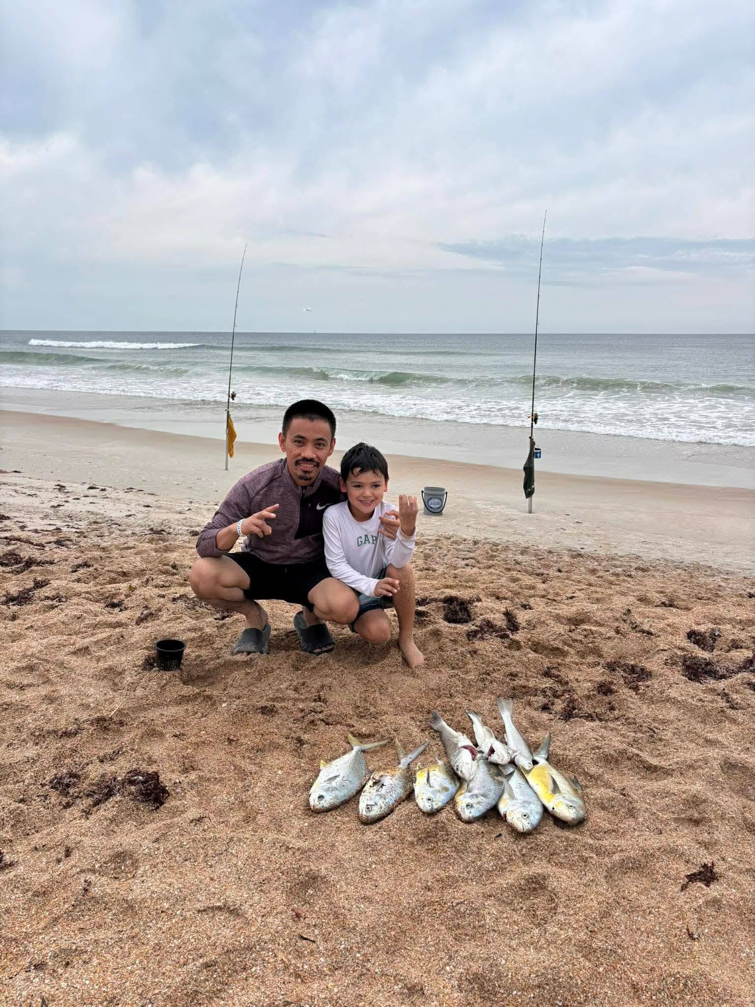 Successful surf fishing trip at New Smyrna Beach FL with multiple fish caught on the beach with fishing rods in background