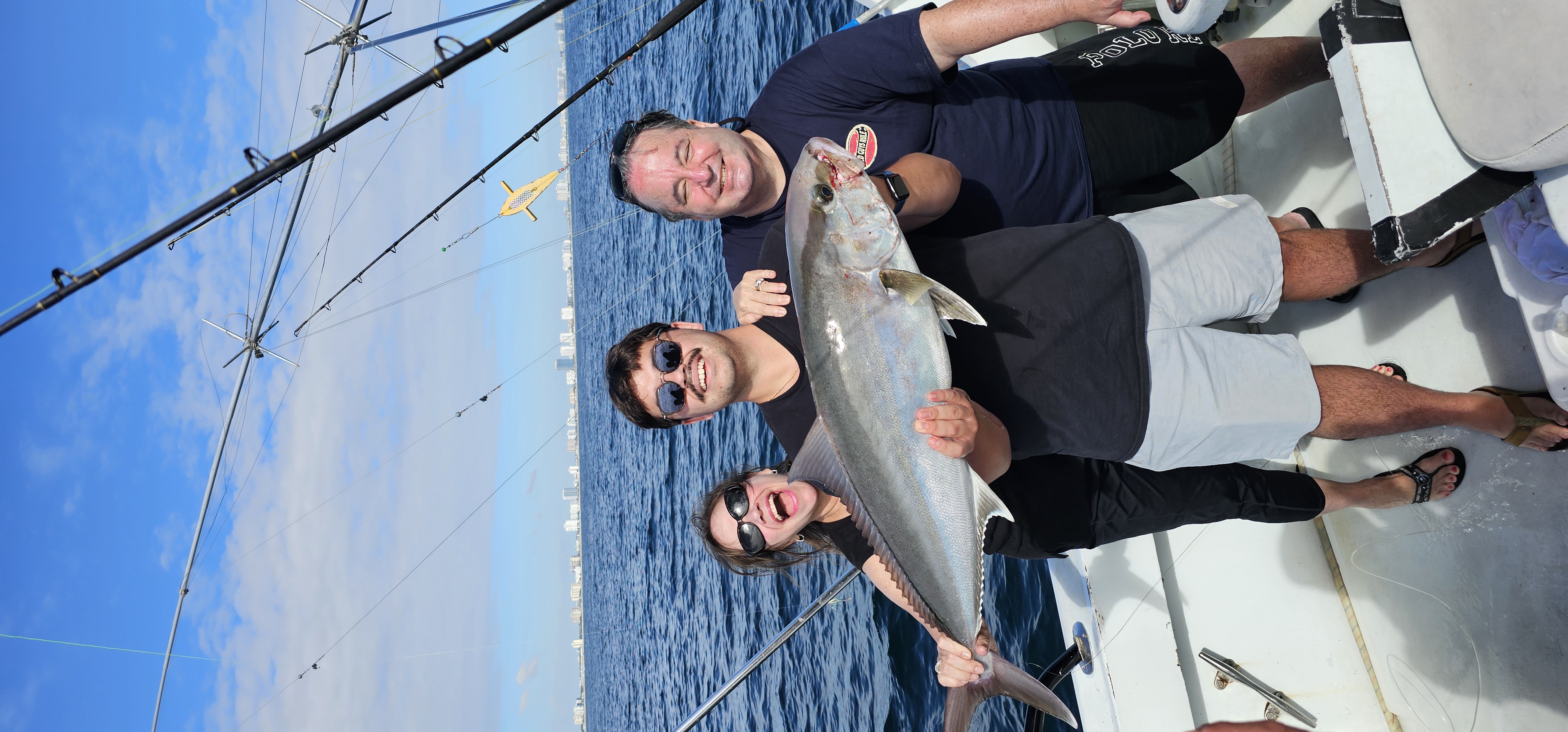 A group of 3 people fishing for a Longfin Yellowtail in Fort Lauderdale