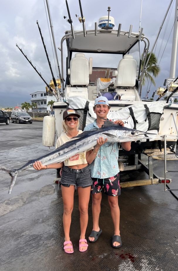 Two anglers with a large fish caught while fishing in Kailua-Kona
