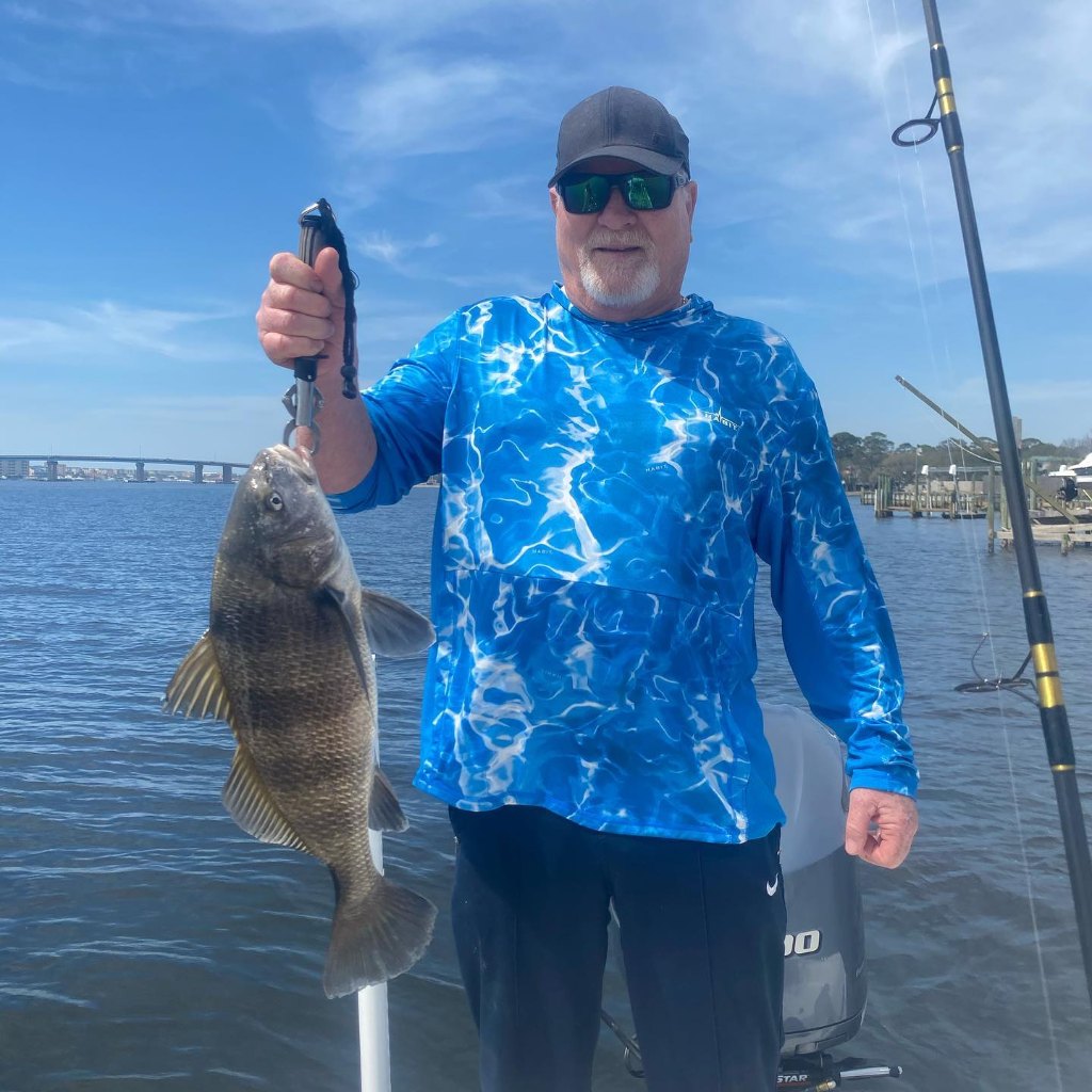 Angler holding a black drum fish in Florida