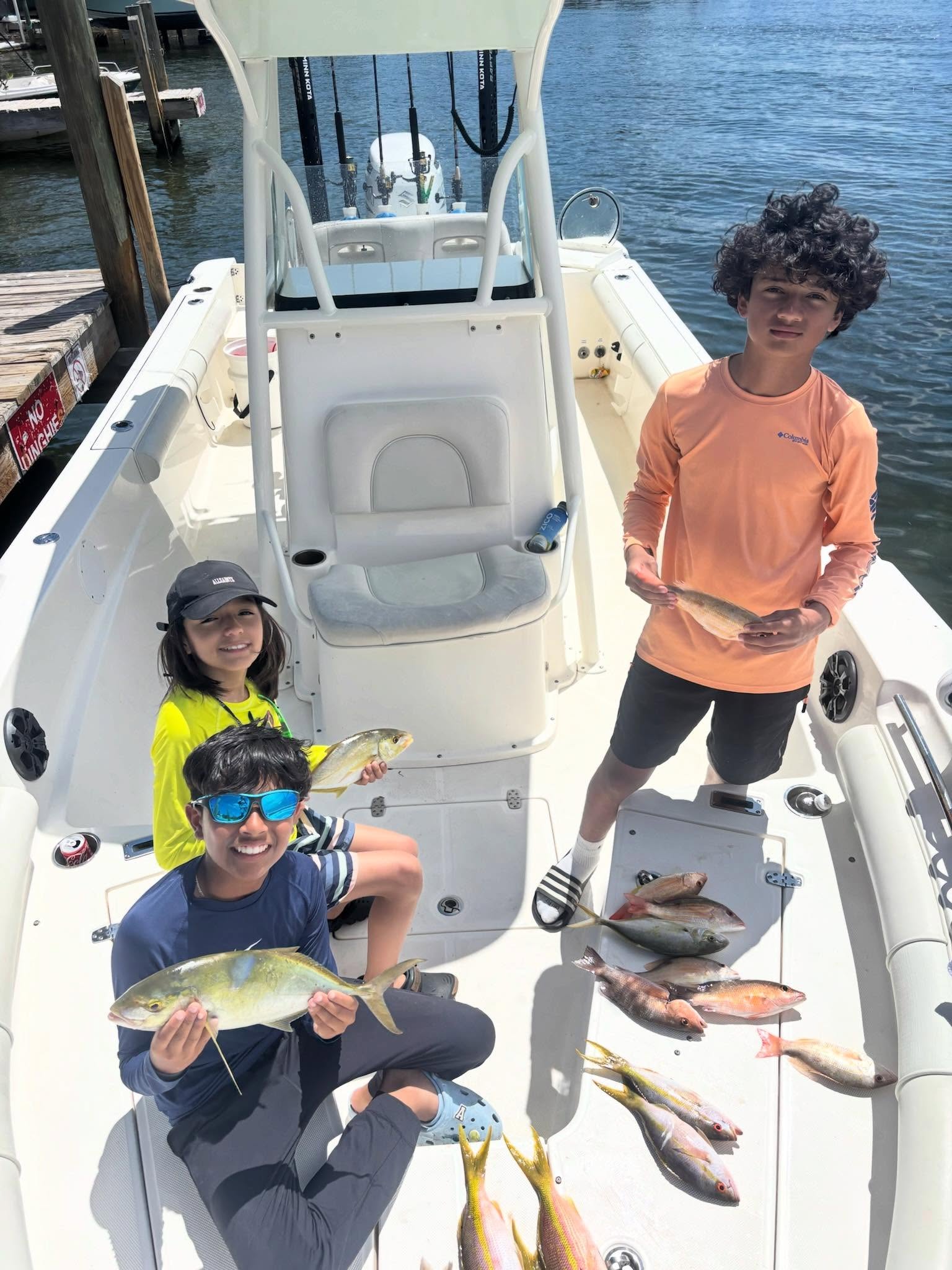 Successful fishing trip in Key Largo FL with multiple fish caught on boat deck