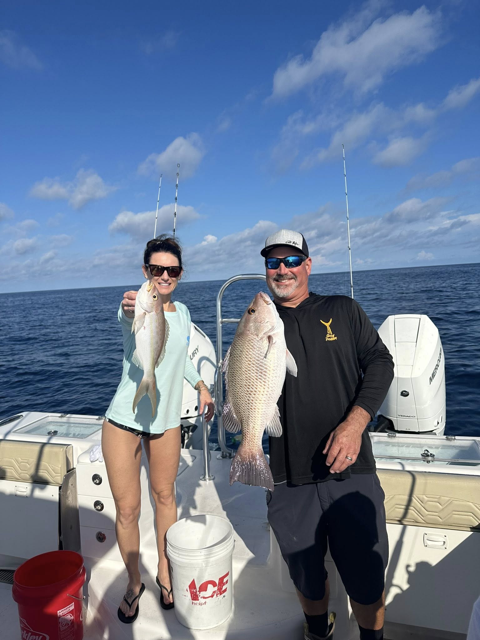 Two anglers display their catch of grey snapper on fishing boat in Fort Myers FL waters