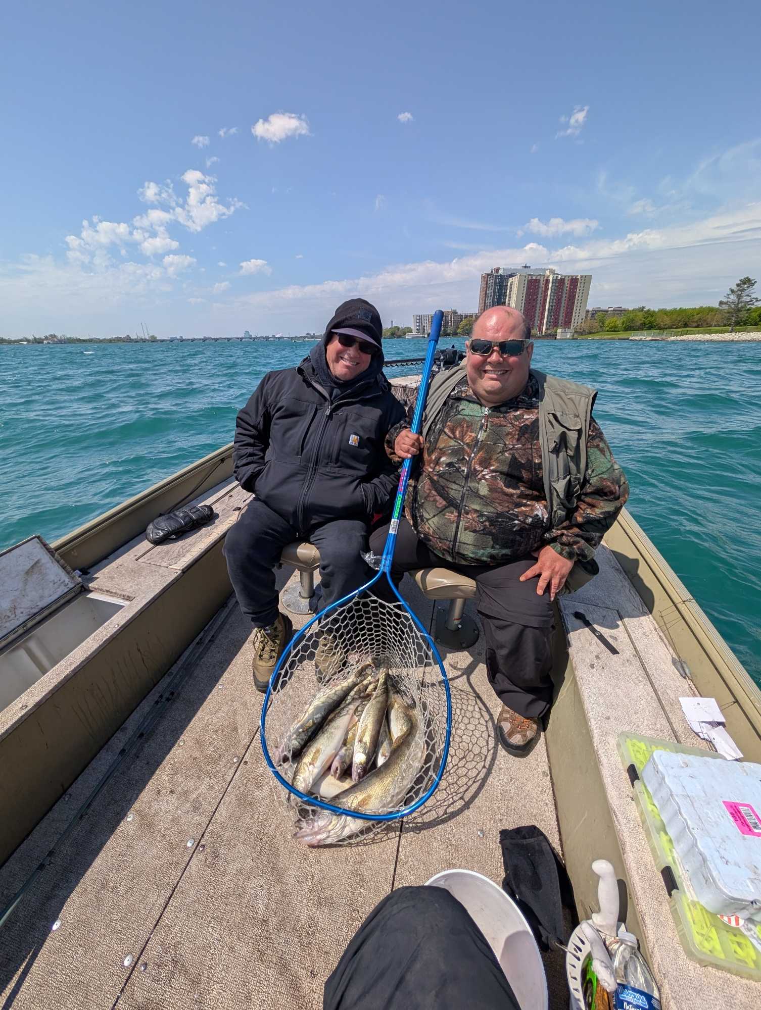 Fishing boat on water with net full of caught fish near Detroit MI waterfront