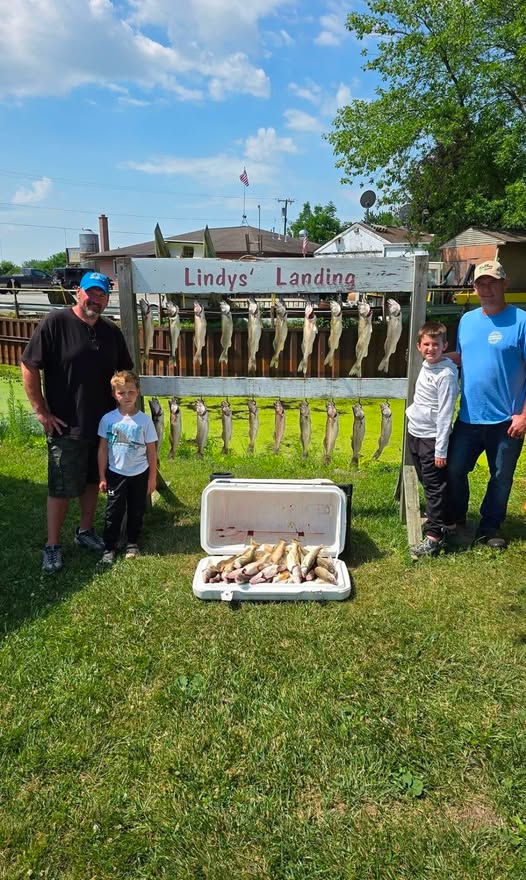 Fishing trip results displayed on rack at Lindys Landing in Whitehall MI with cooler of fish