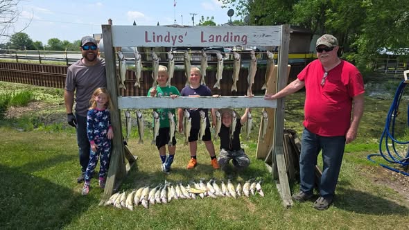 Successful fishing trip display with multiple fish hanging on cleaning station at Whitehall MI