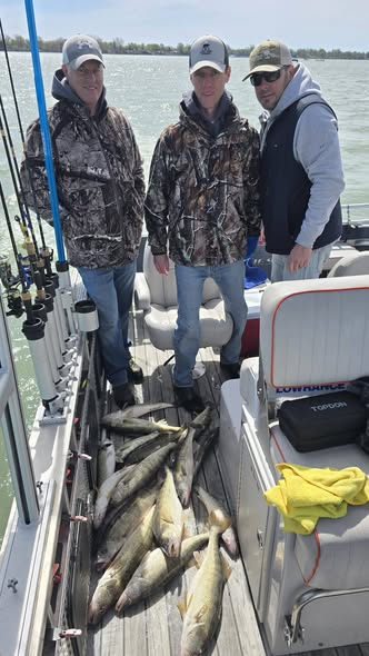 Successful walleye fishing trip on boat in Whitehall MI with multiple caught fish on deck