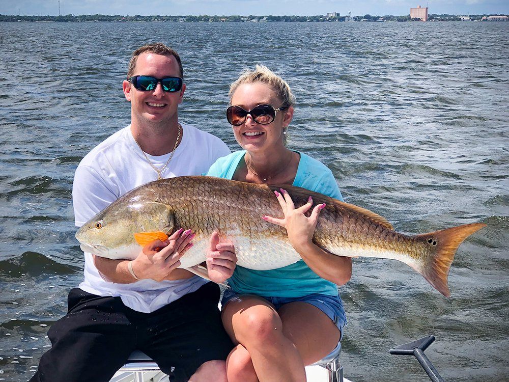 Two anglers in FL holding a 35-inch fish