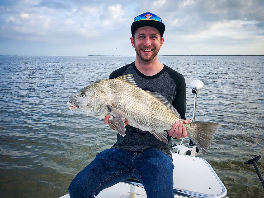 Angler with a black drum fish caught in FL