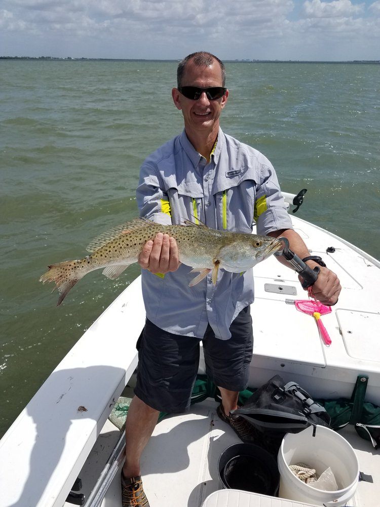 Successful angler holding a 24-inch fish in FL
