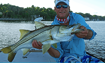 A fisherman holds a snook, a 27-inch fish, in Cape Coral