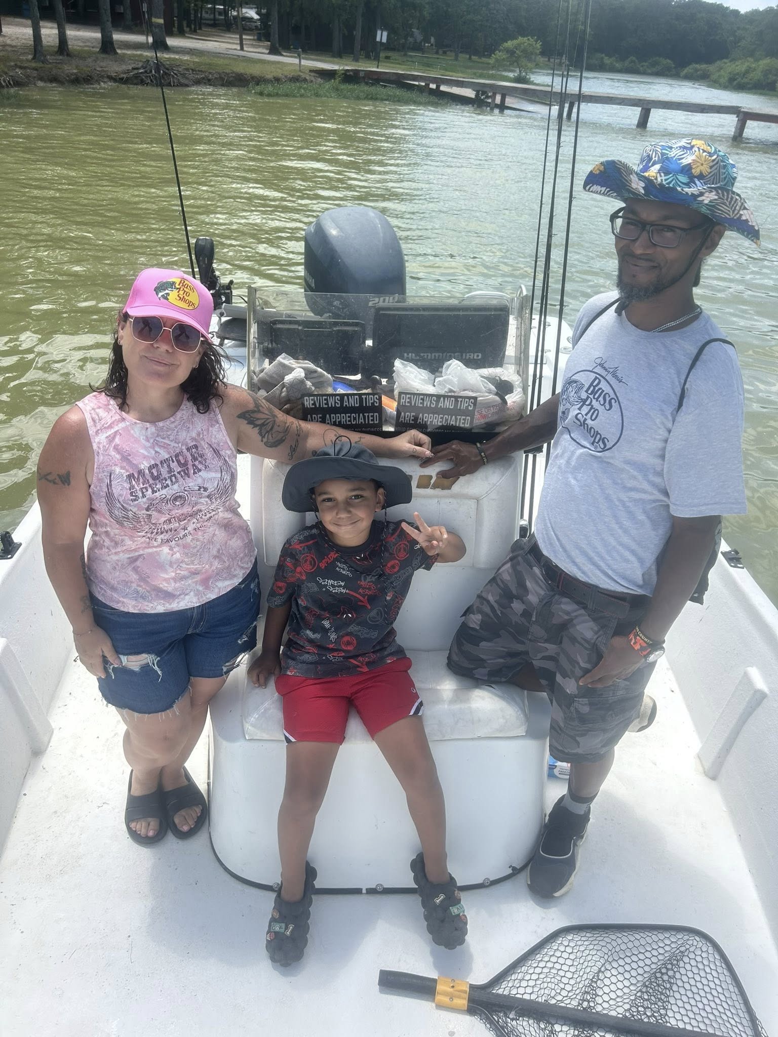 Family fishing trip on boat in Quinlan TX with fishing equipment and lake scenery