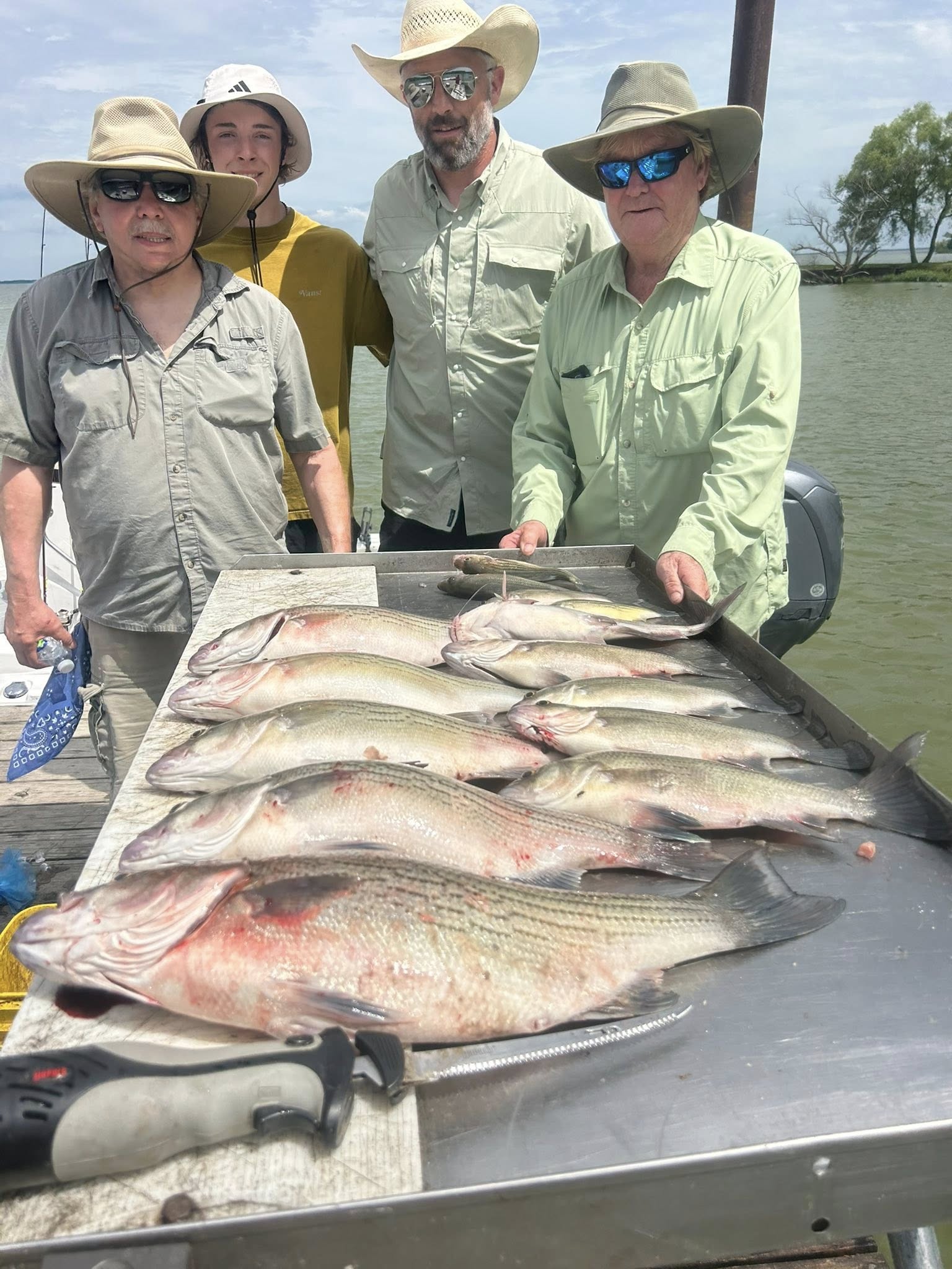 Fishing charter catch of striped bass and bowfin displayed on boat cleaning station in Quinlan TX