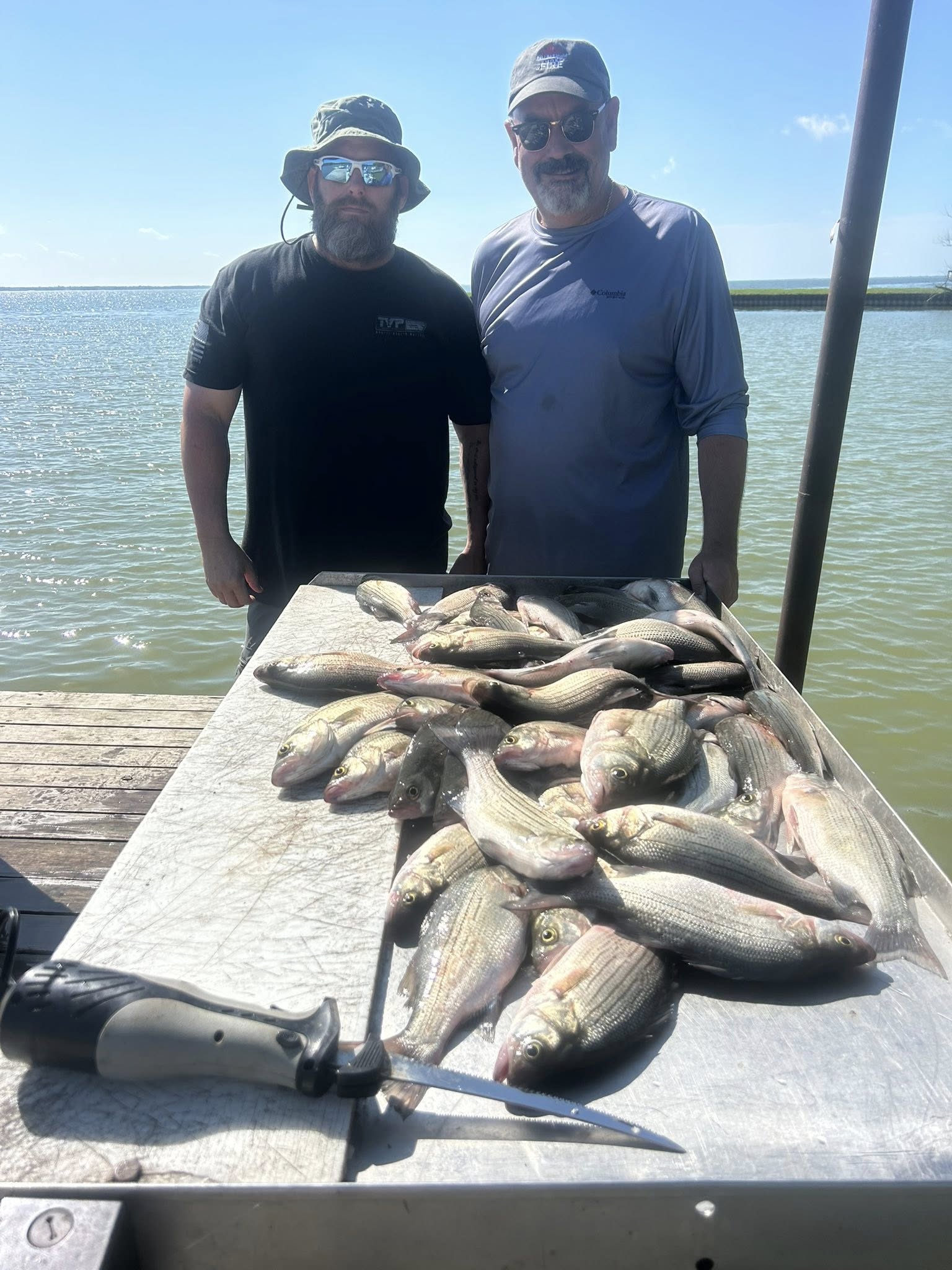 Large catch of white bass displayed on boat deck after successful fishing trip in Quinlan TX
