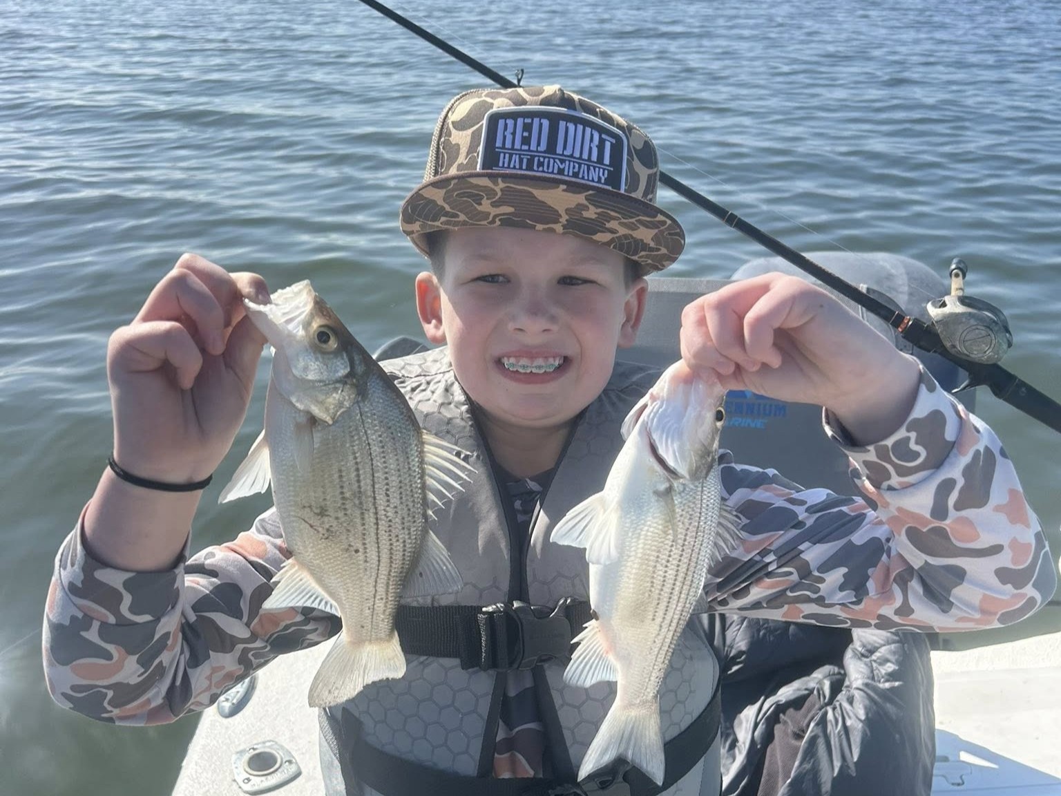 Family fishing boat on Lake Tawakoni with guide Brett Kilmer teaching kids to catch bass