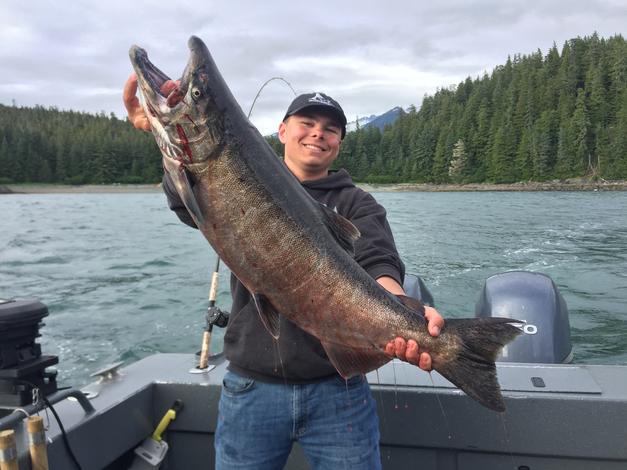 Guided salmon fishing charter boat in Juneau Alaska waters with anglers and equipment