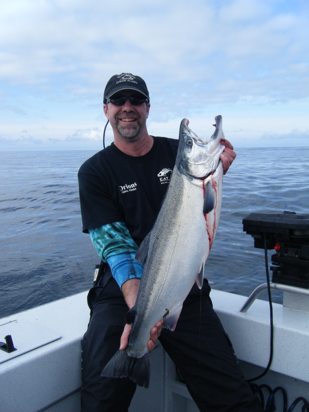 Juneau Alaska salmon fishing charter boat with anglers casting lines in productive inshore waters