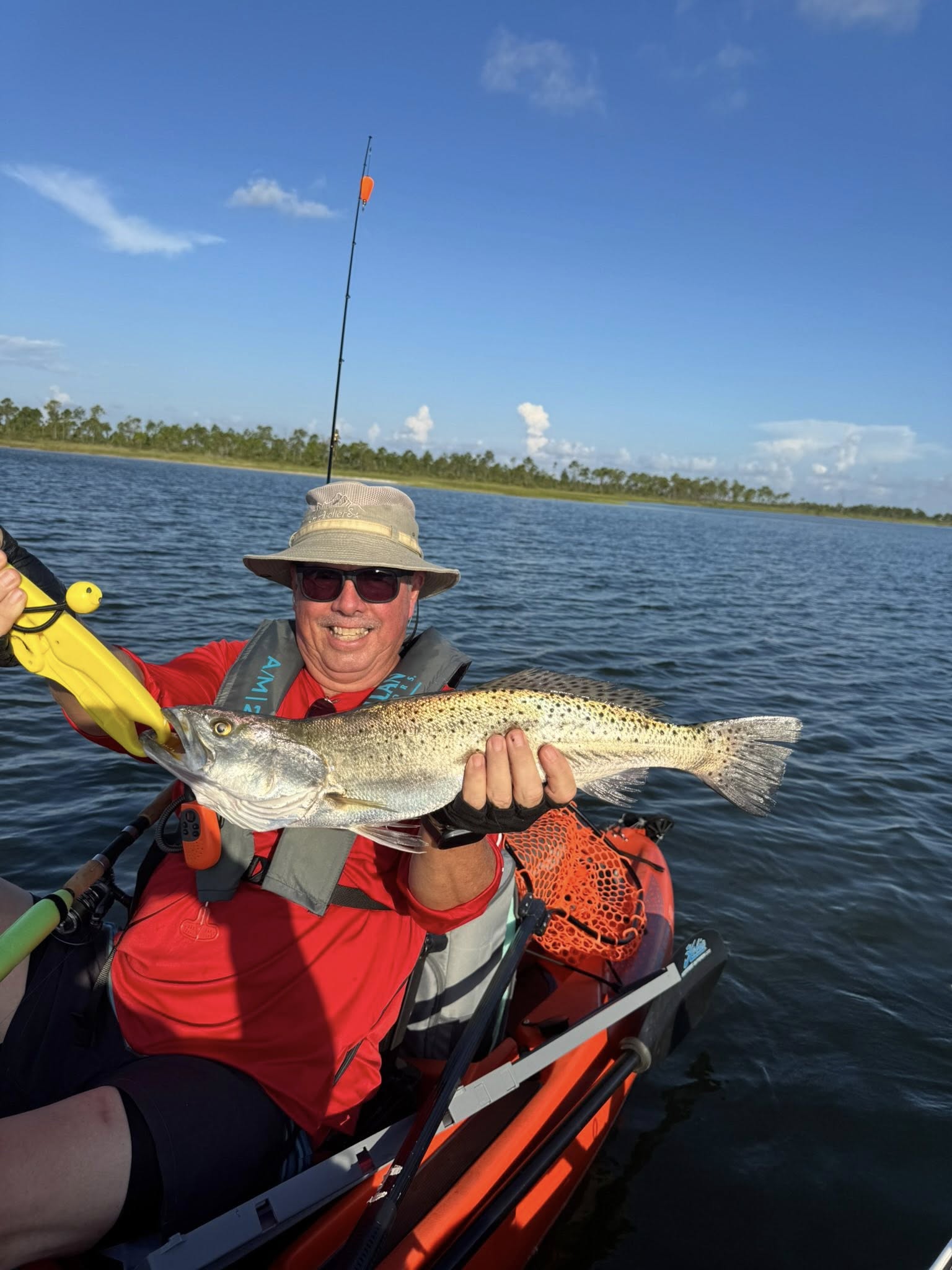 A fisherman catches a spotted weakfish in Enterprise