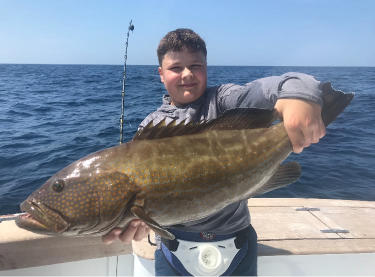 Fisherman holding a 27-inch fish in FL