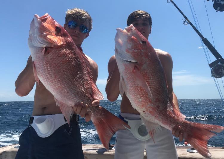 A person fishing in Destin, Florida with 2 fish