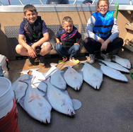 A group of 3 people fishing in Alaska