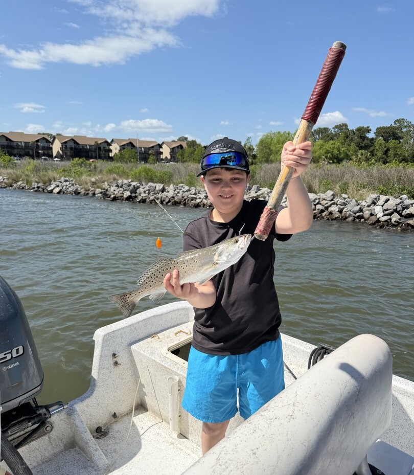 Speckled trout caught fishing in Gulf Shores AL with fishing rod on boat