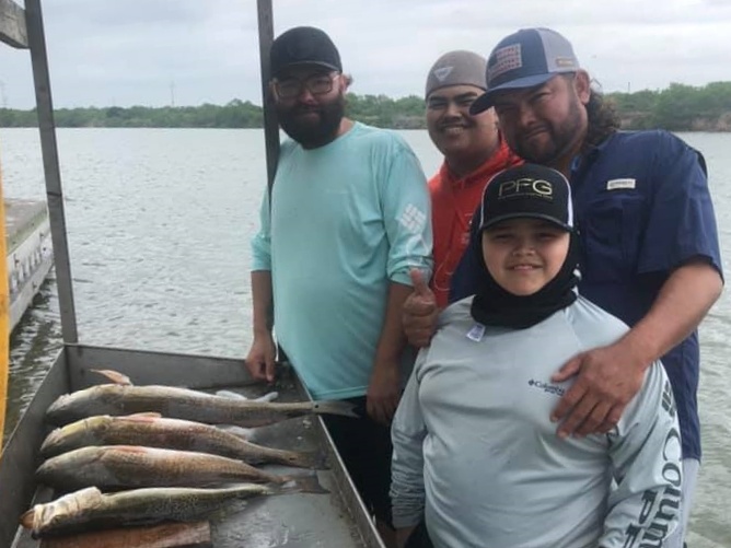 A group of 4 people enjoying a fishing trip at South Padre Island