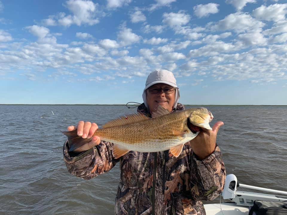 Angler holding a fish in Saint Bernard