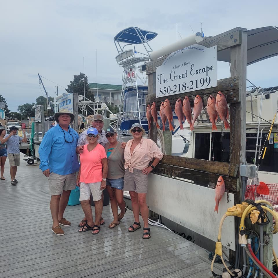 Group of 7 people fishing at Destin with 3 big fish caught