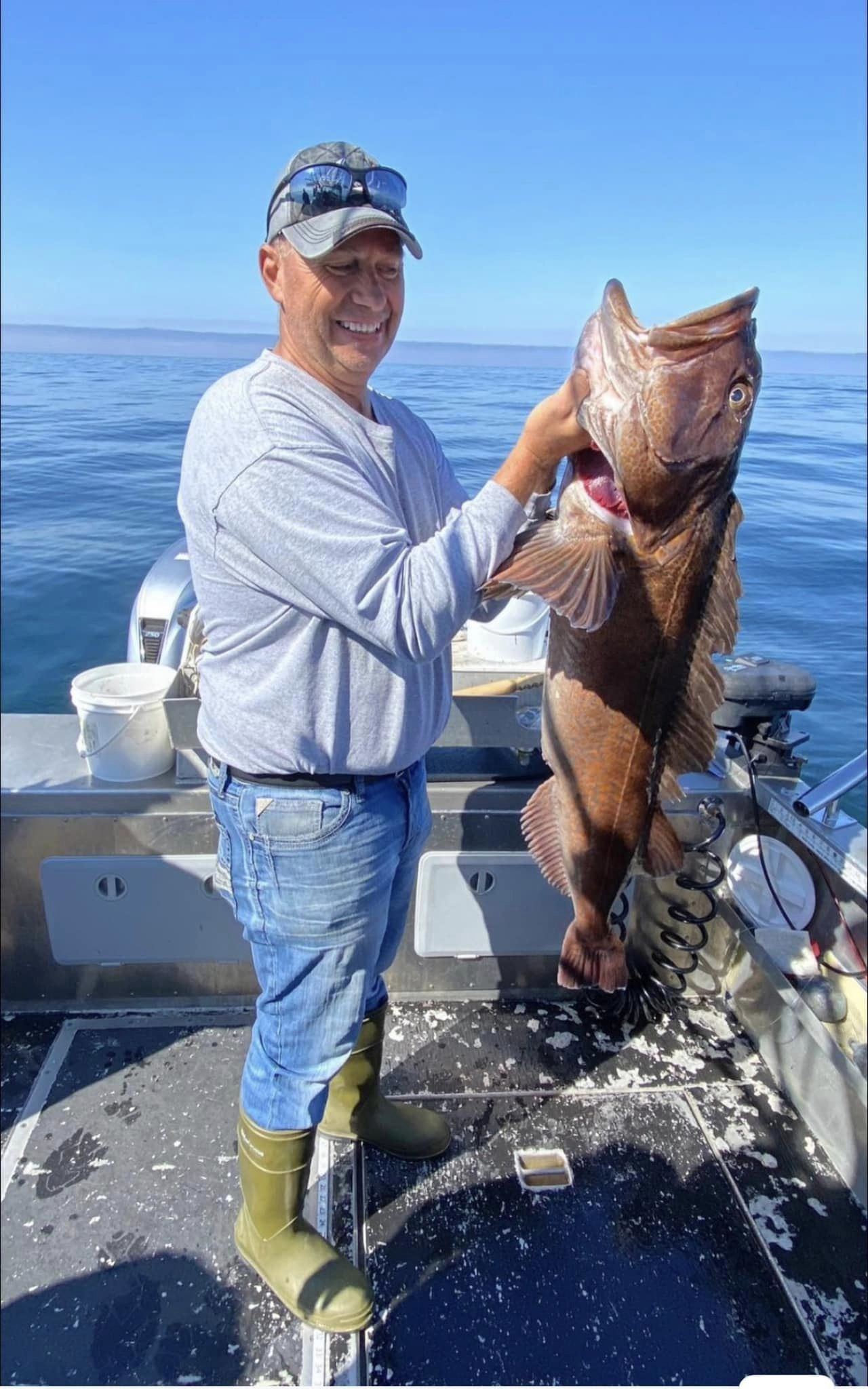 A lone fisherman at the shore, reeling in a big catch in Alaska