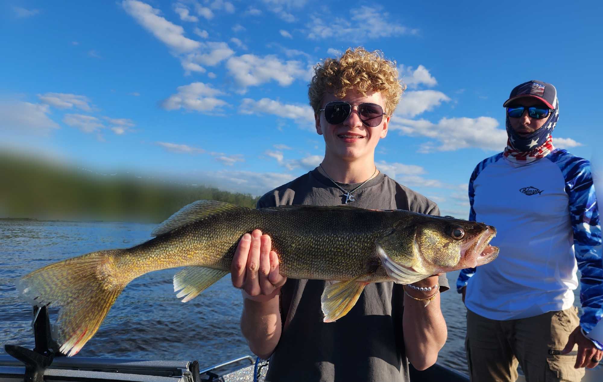 Walleye caught while fishing in Breezy Point Minnesota on lake with blue sky
