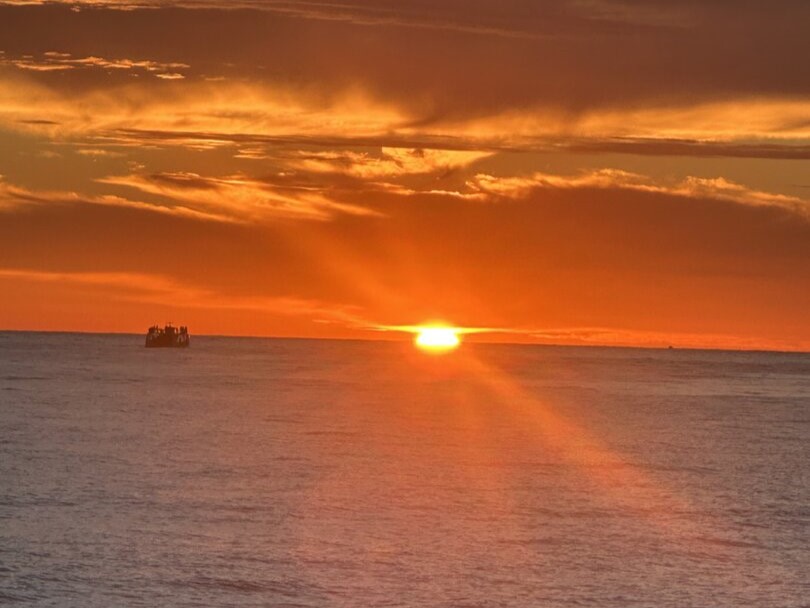 Quepos sunset cruise boat departing Marina Pez Vela with guests enjoying coastal views near Manuel Antonio