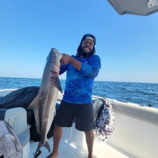 A lone fisherman reeling in a catch in Jacksonville