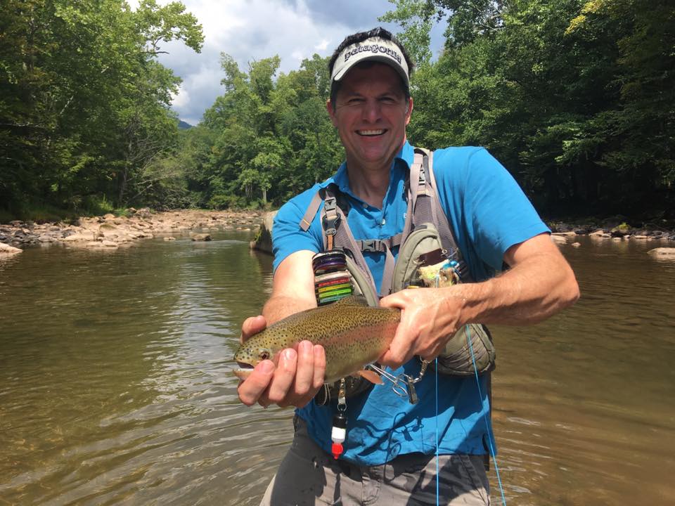 Fisherman catching a rainbow trout in Charlottesville