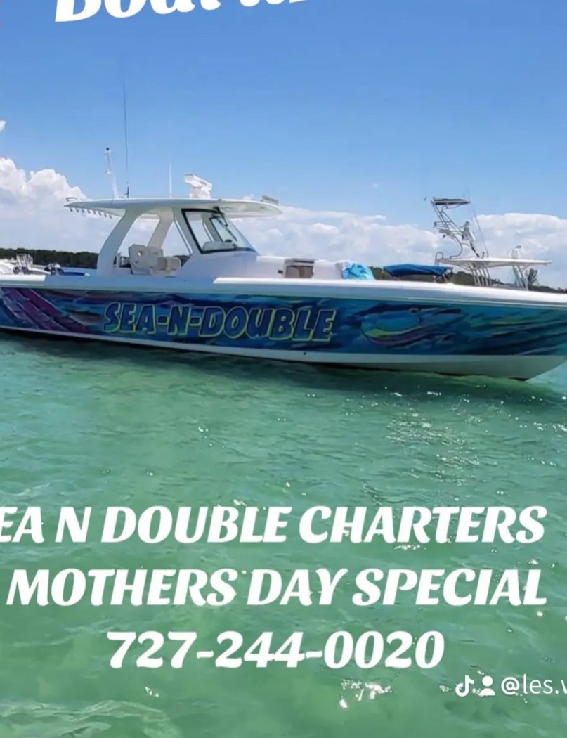 Sea N Double charter boat with blue and white hull floating on clear turquoise water in St. Petersburg FL