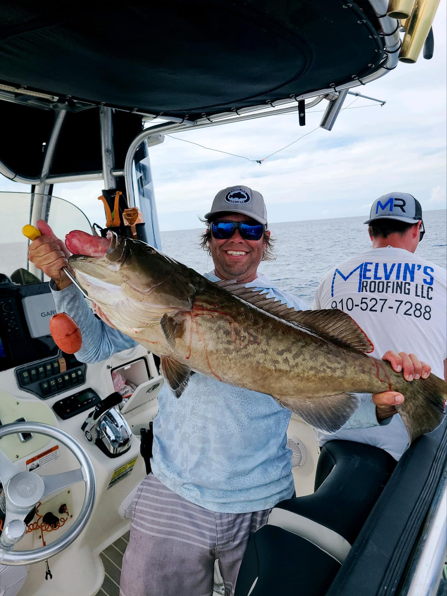 Angler with a large gag grouper fish in Oak Island