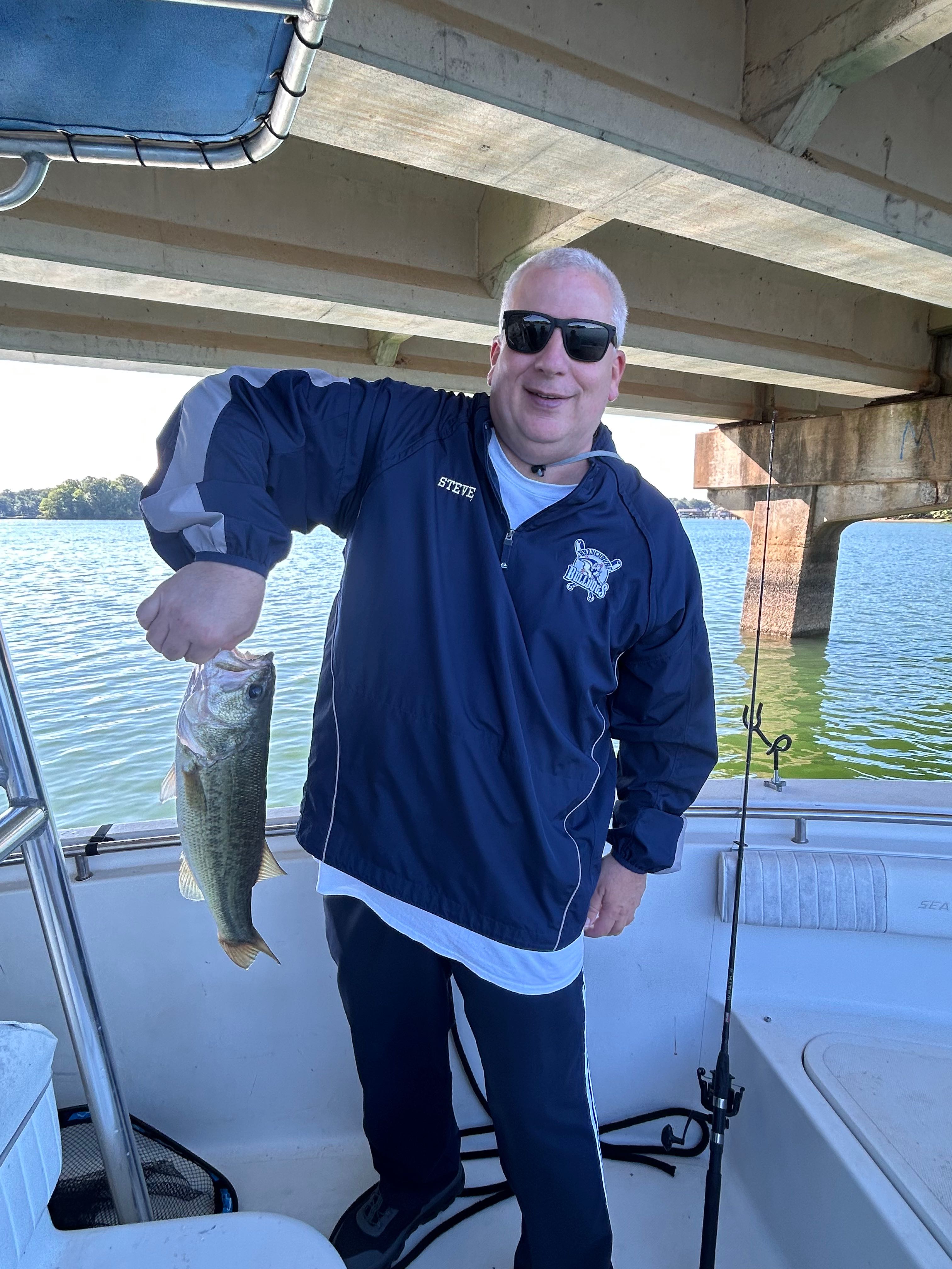 Fresh caught bass held on fishing boat in Denver NC waters