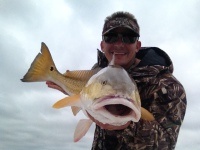 Single fisherman catching a 17-inch fish in Galveston