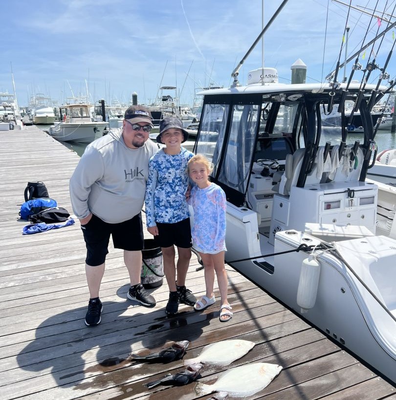 Successful fishing trip at Rehoboth Beach DE marina with fresh caught fish displayed on dock