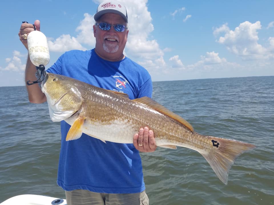 Angler holding a 29-inch fish at Lake Charles