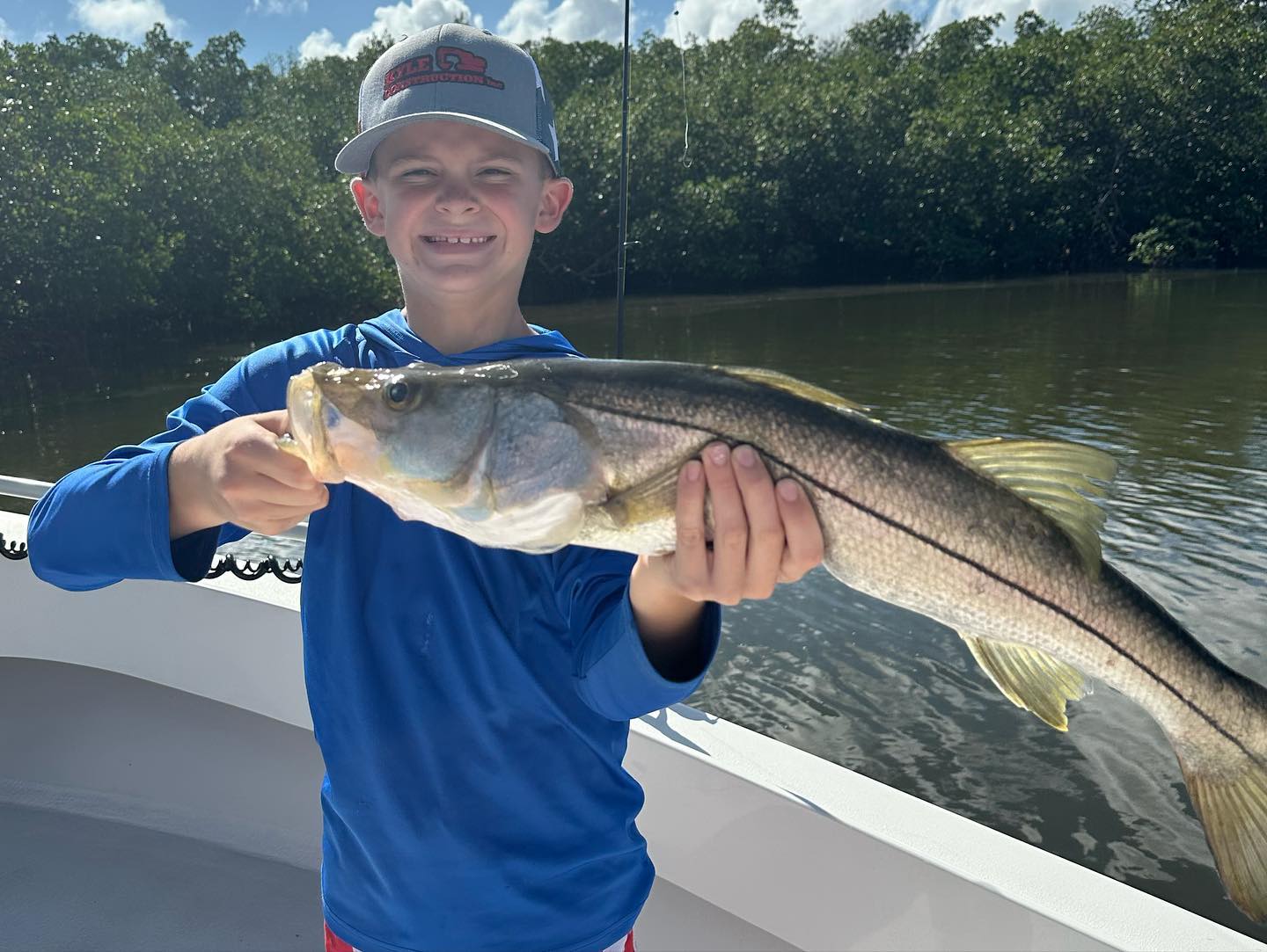 A fisherman with a big snook fish catch in FL