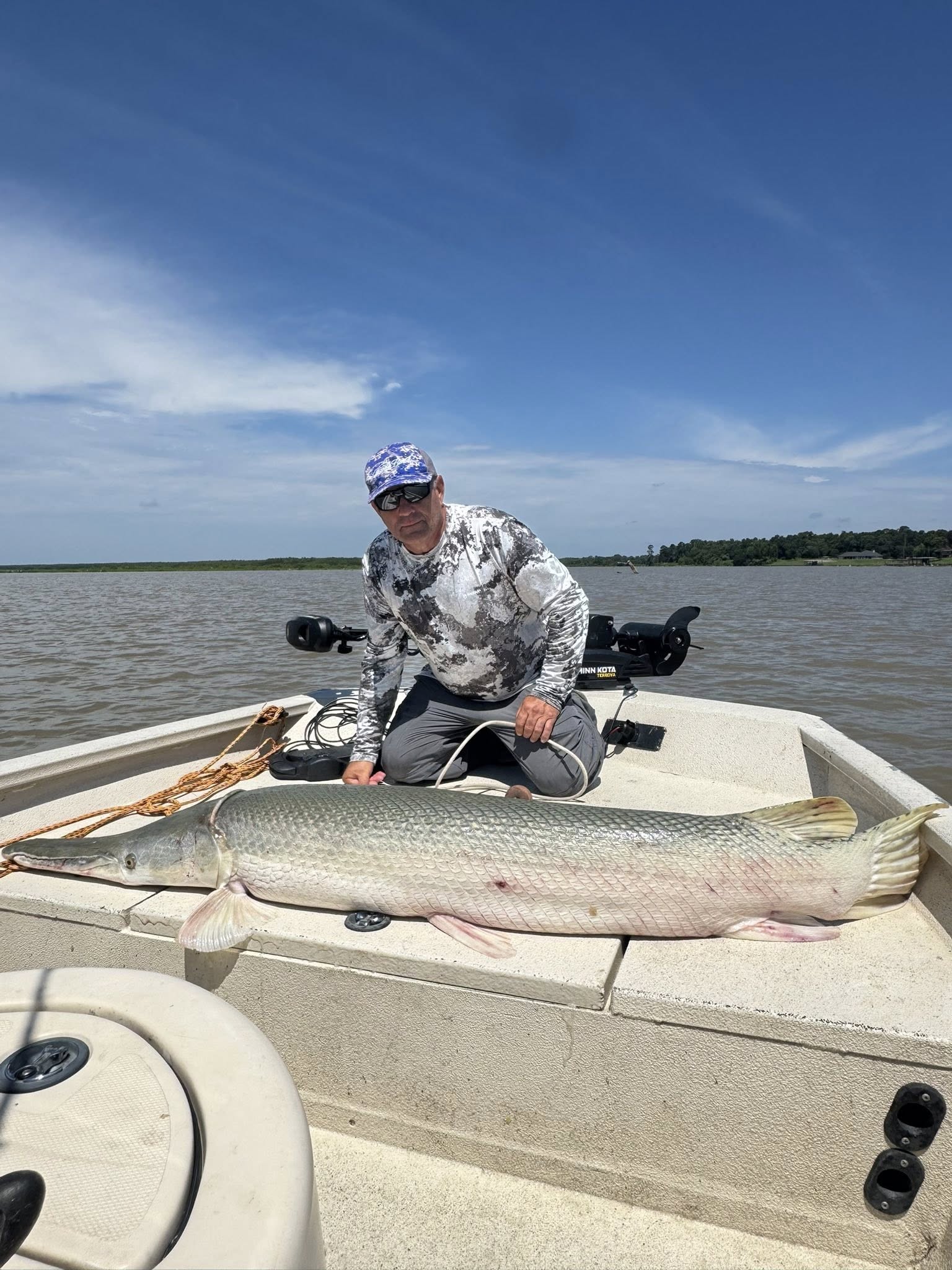Large alligator gar caught fishing in Palestine Texas displayed on boat deck