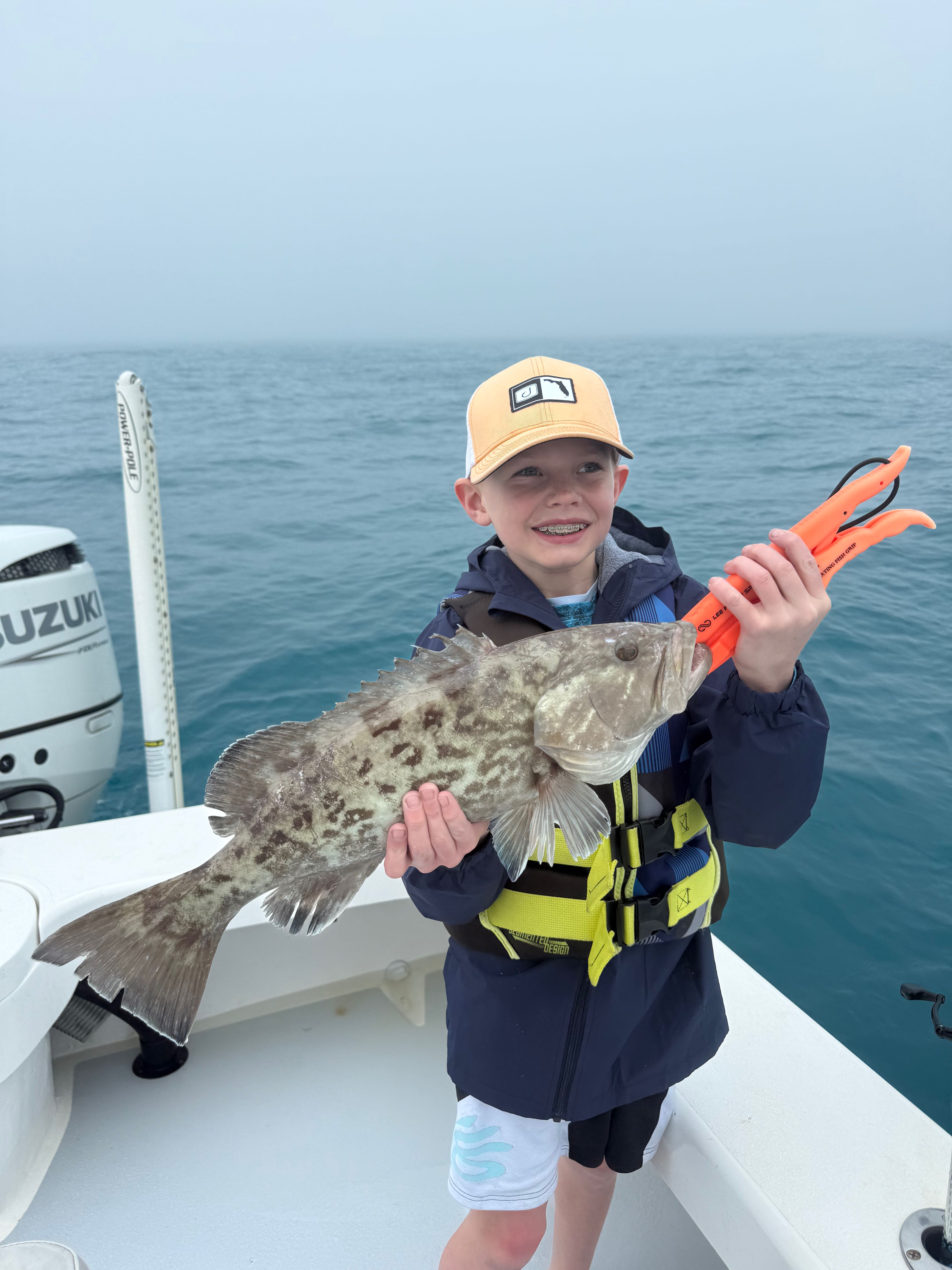 Gag grouper catch displayed on fishing boat in Cortez FL waters