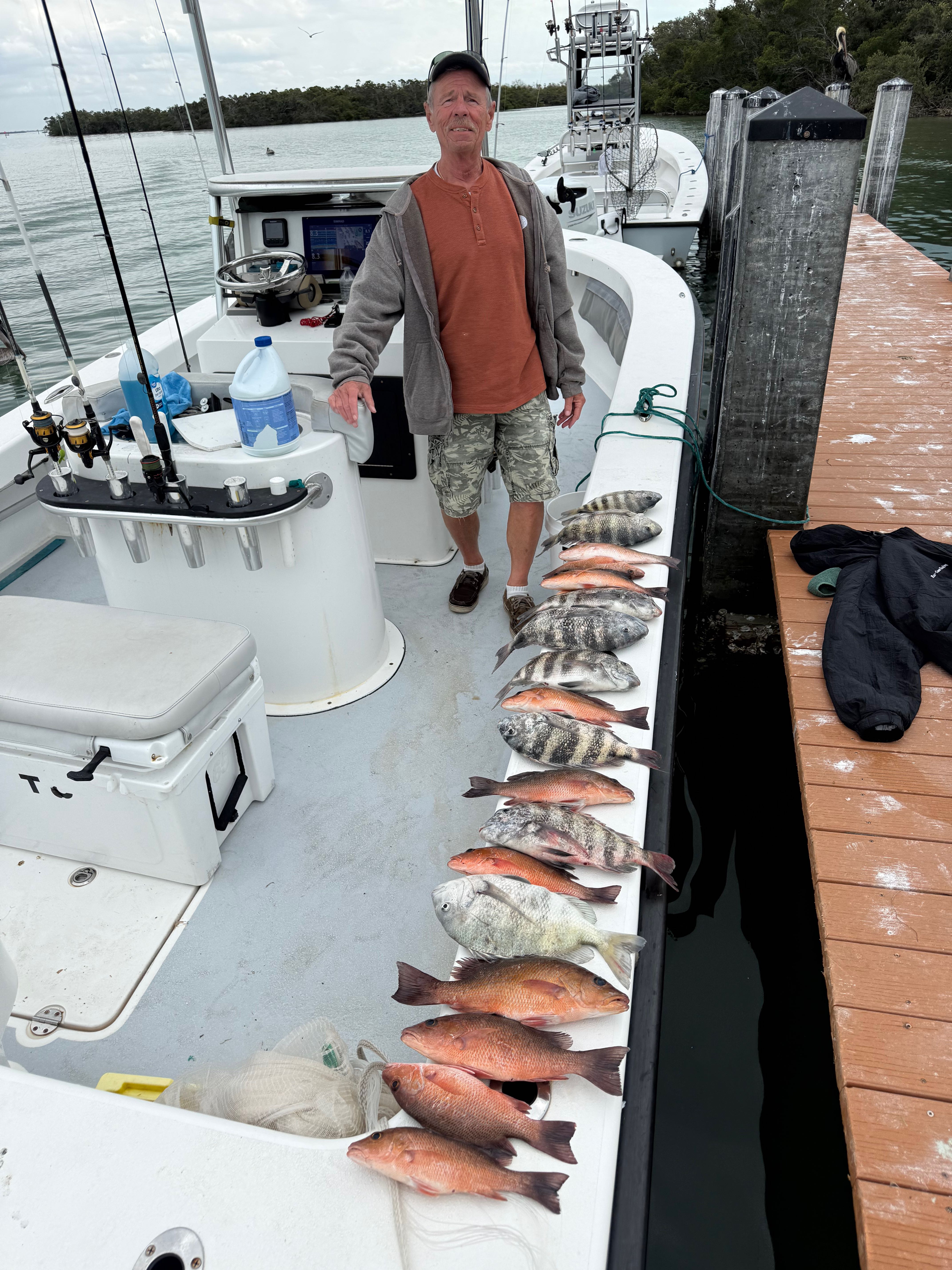 Fishing charter catch display showing grey snapper lined up on boat deck in Cortez FL