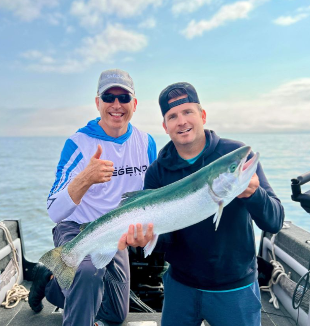 Two people fishing in Ontario, with a 28-inch catch