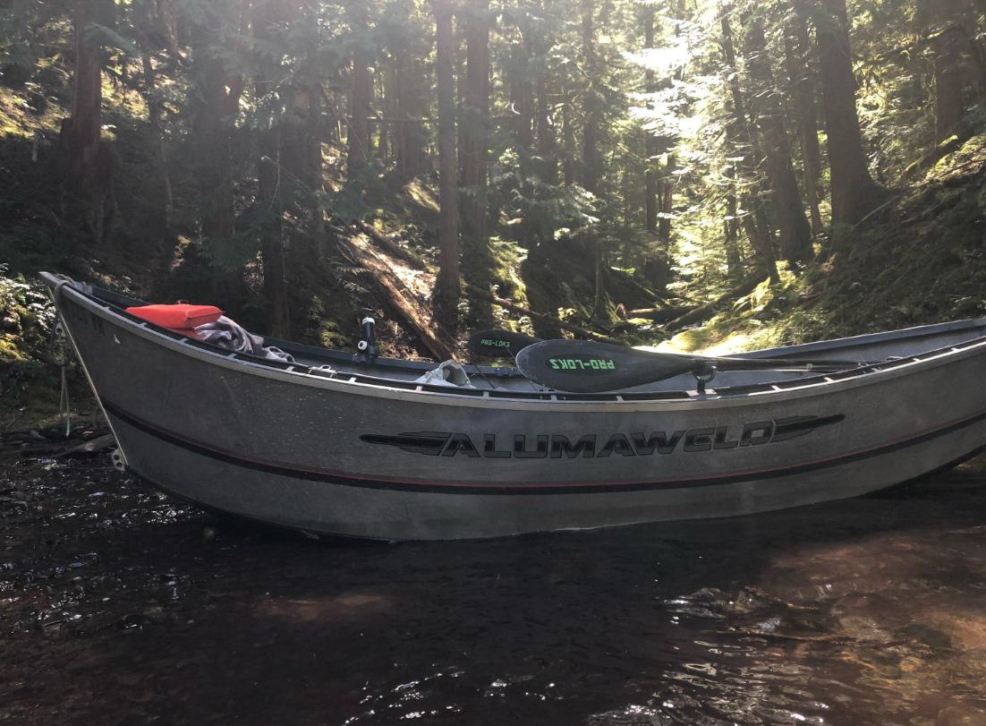 Alumaweld fishing boat positioned in forest stream in Clackamas Oregon
