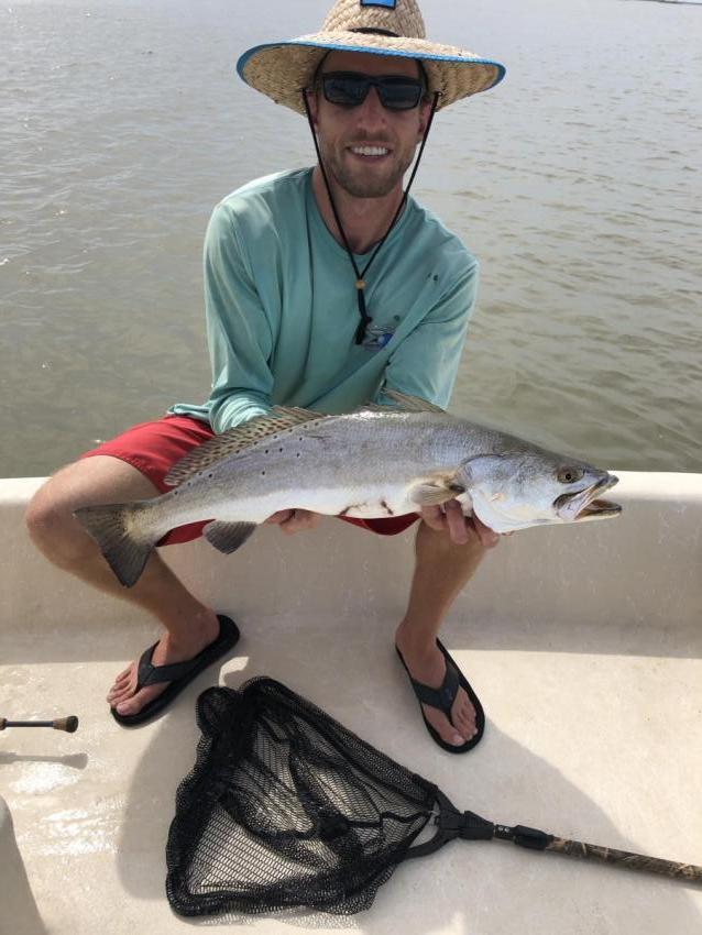 Image of a fisherman with a large fish in Freeport