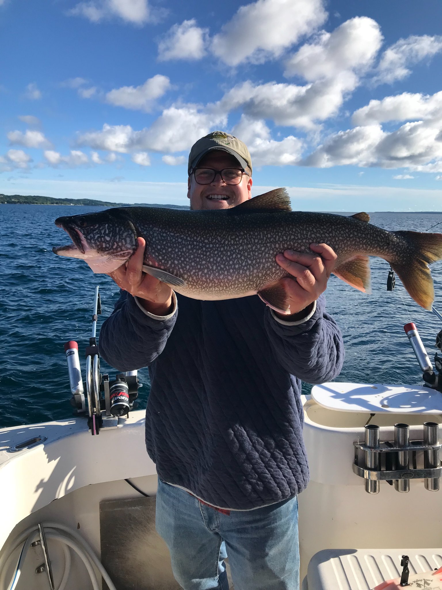 Successful angler holding a large lake trout in MI