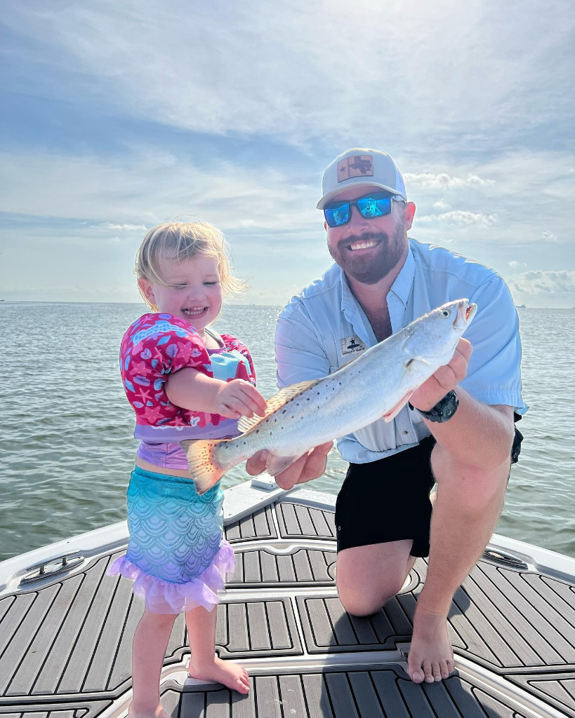 Two anglers standing near the water in TX