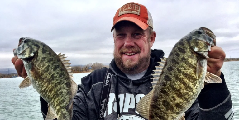 Two fishing rods in the water with a beautiful scenic background in Loveland